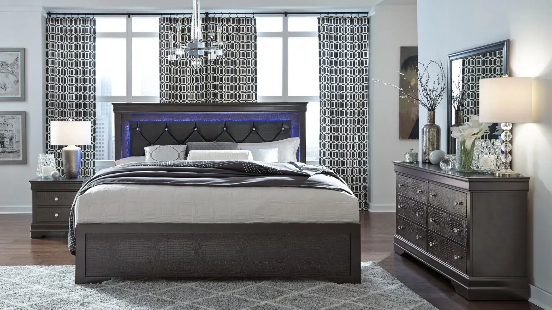 Bedroom set: bed with lighted headboard, nightstand, dresser, and mirror in a modern style.