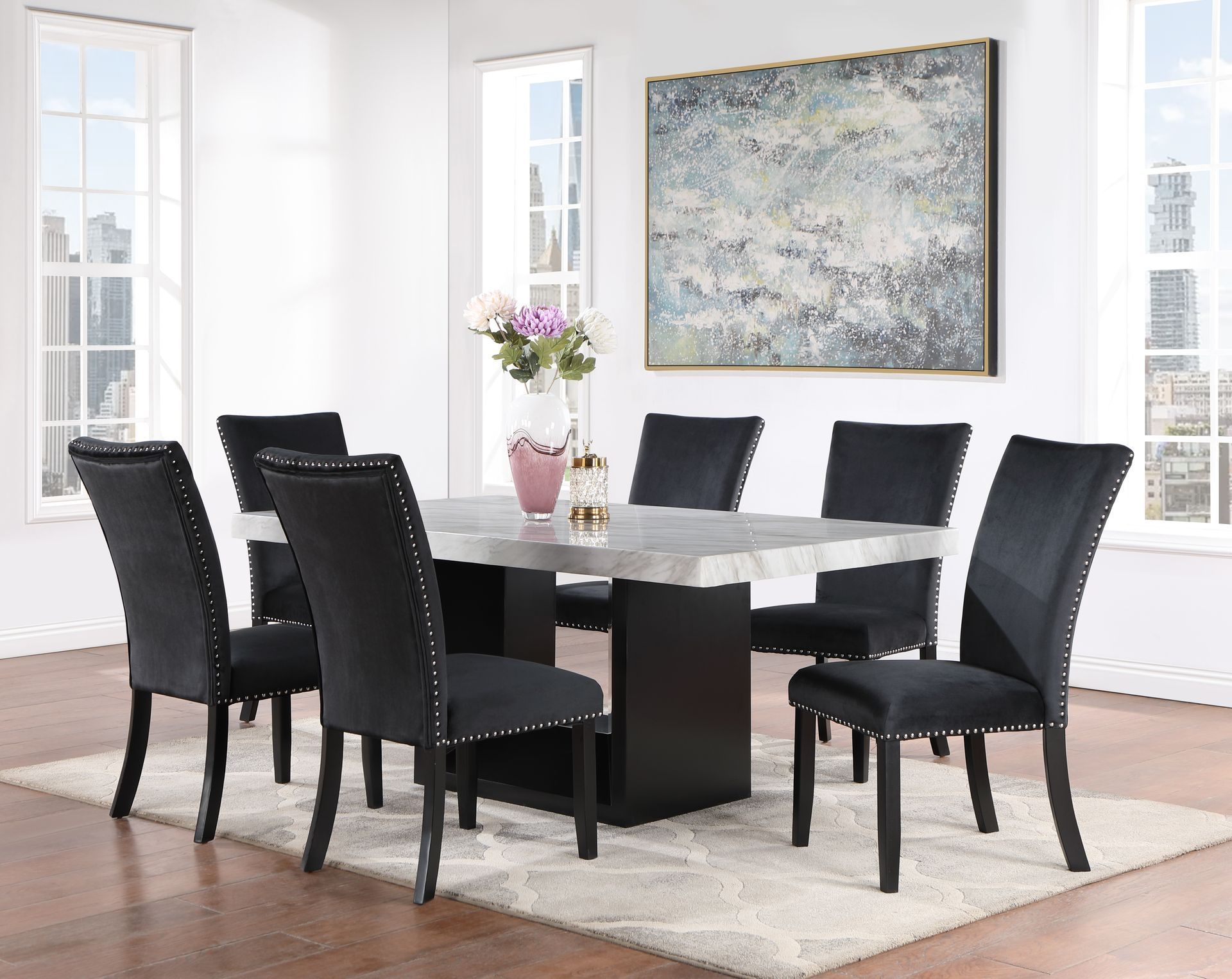 A dining room with a white table and black chairs
