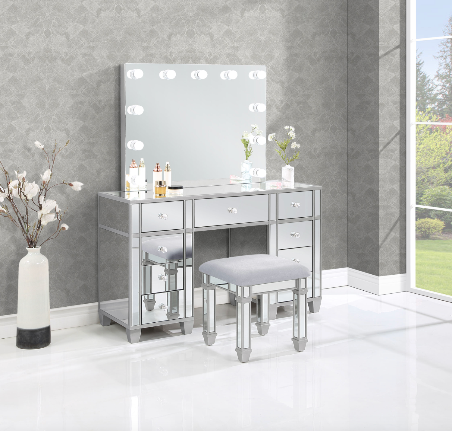 A vanity with a mirror and a stool in a room.