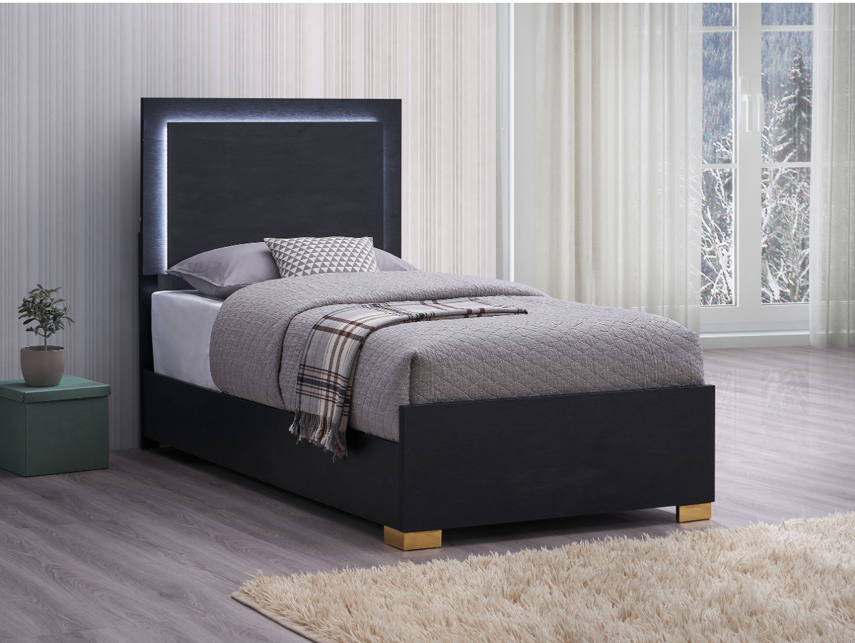 A black bed with a lighted headboard is in a bedroom.