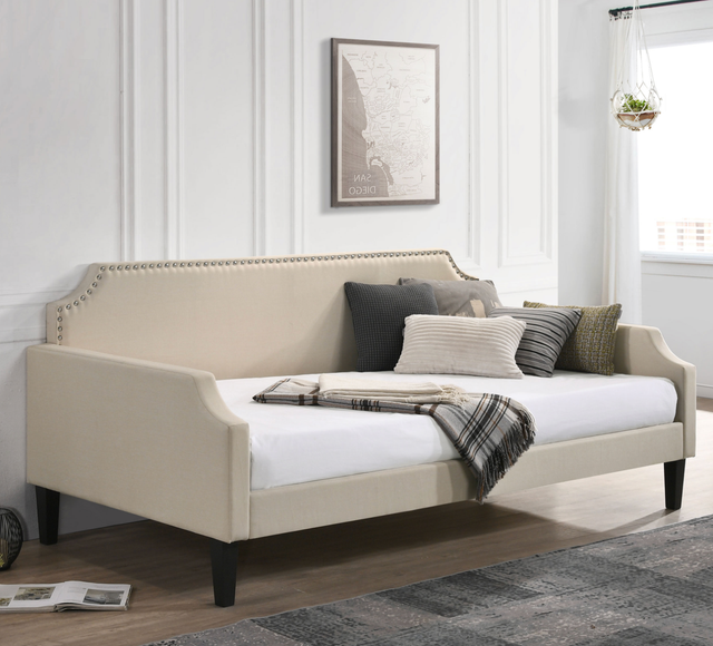 A day bed with pillows and a blanket on it