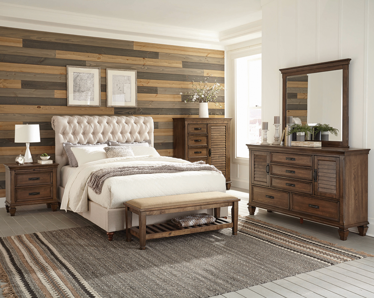 A bedroom with a bed , dresser , mirror and nightstand.
