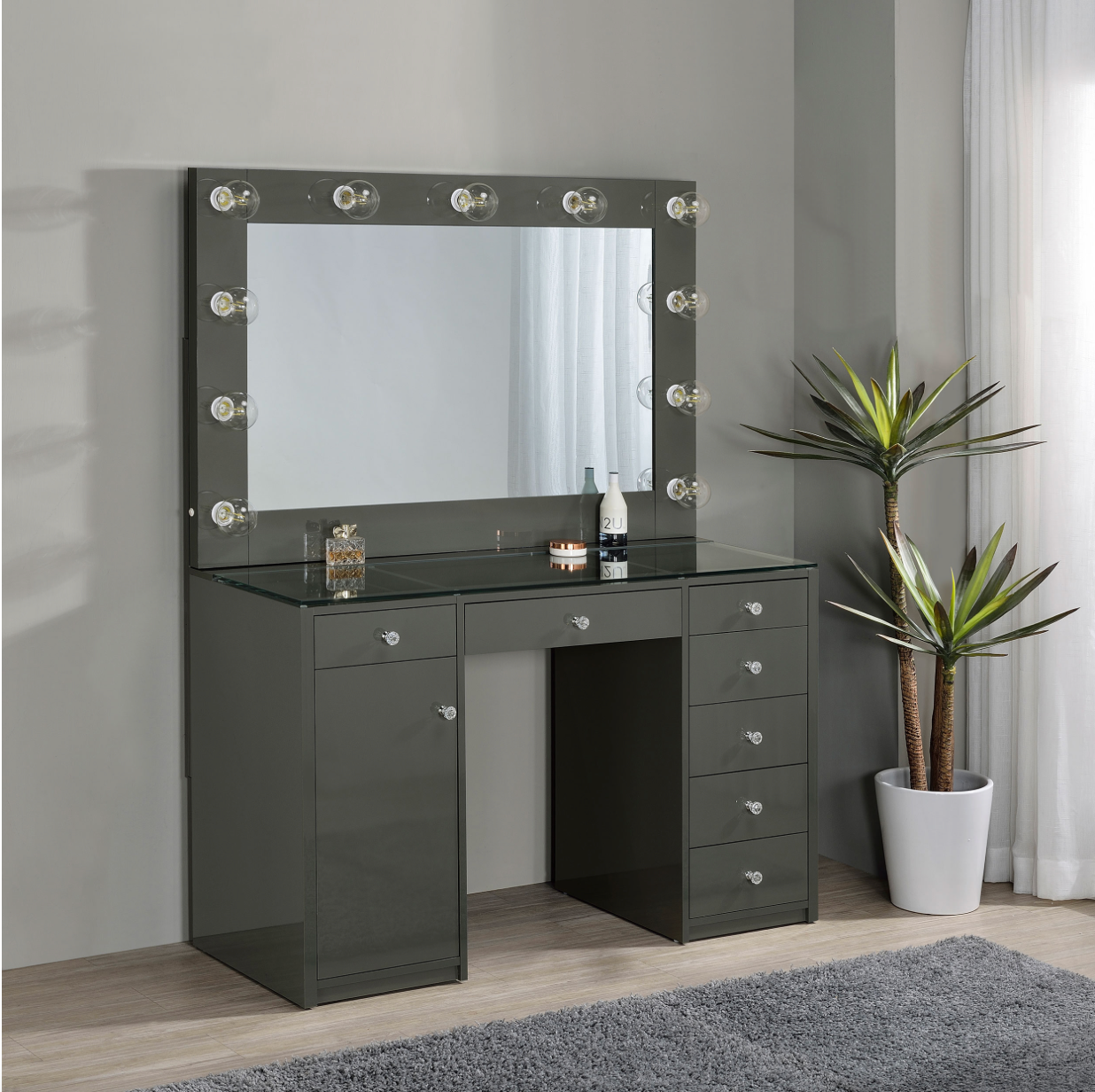 A vanity with a mirror and lights on it in a room.