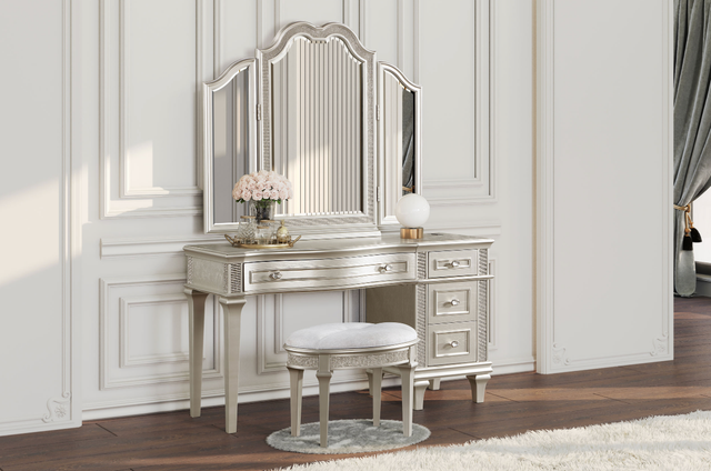 A vanity with a mirror and a stool in a bedroom.