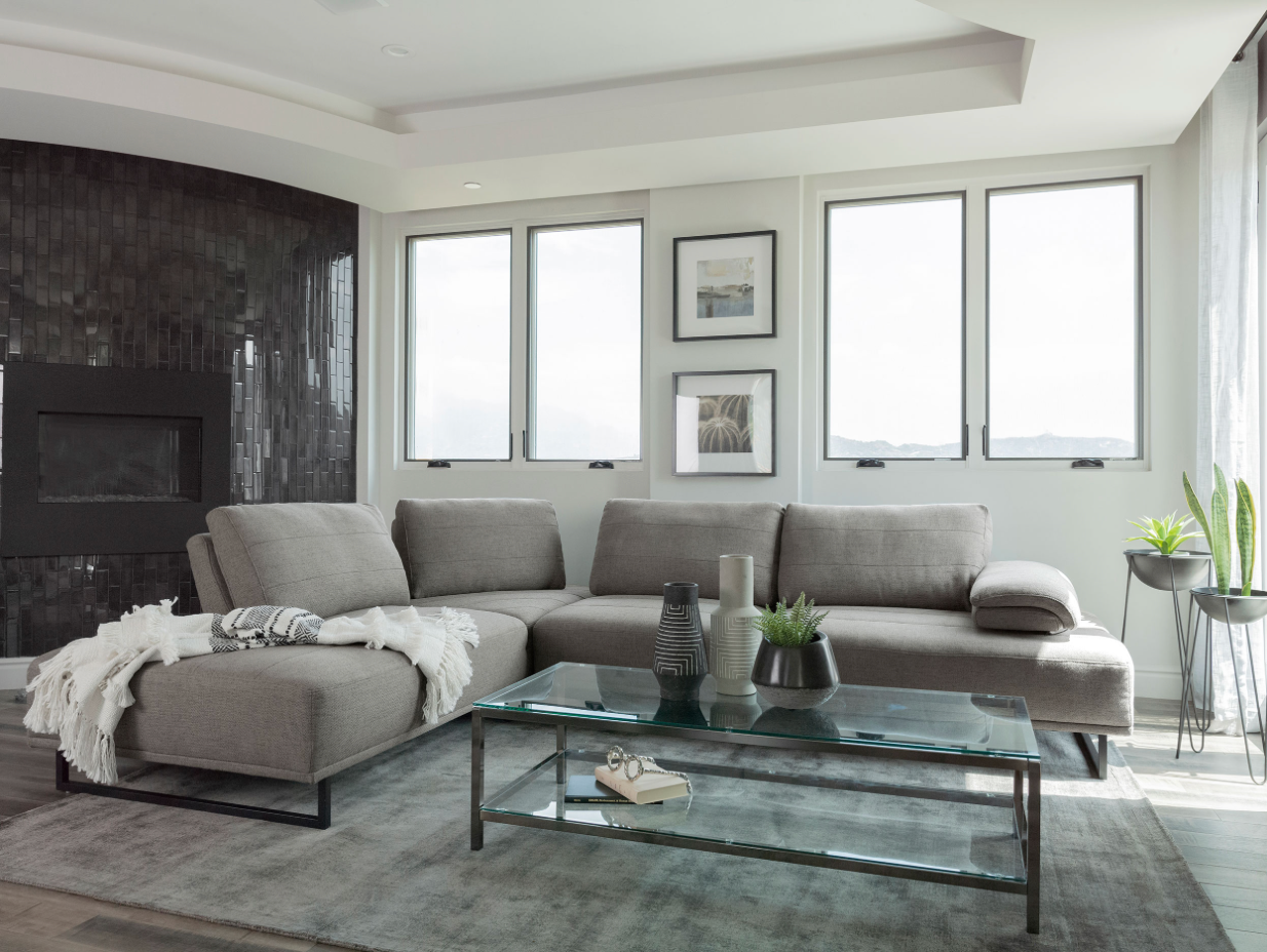 A living room with a couch , coffee table , and fireplace.