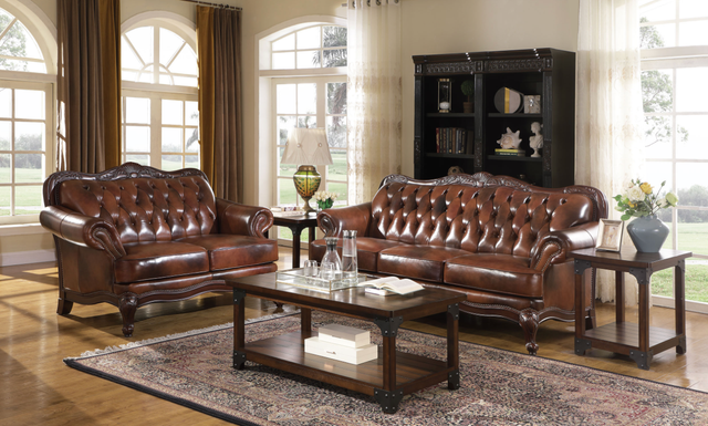 A living room with brown leather furniture and a coffee table