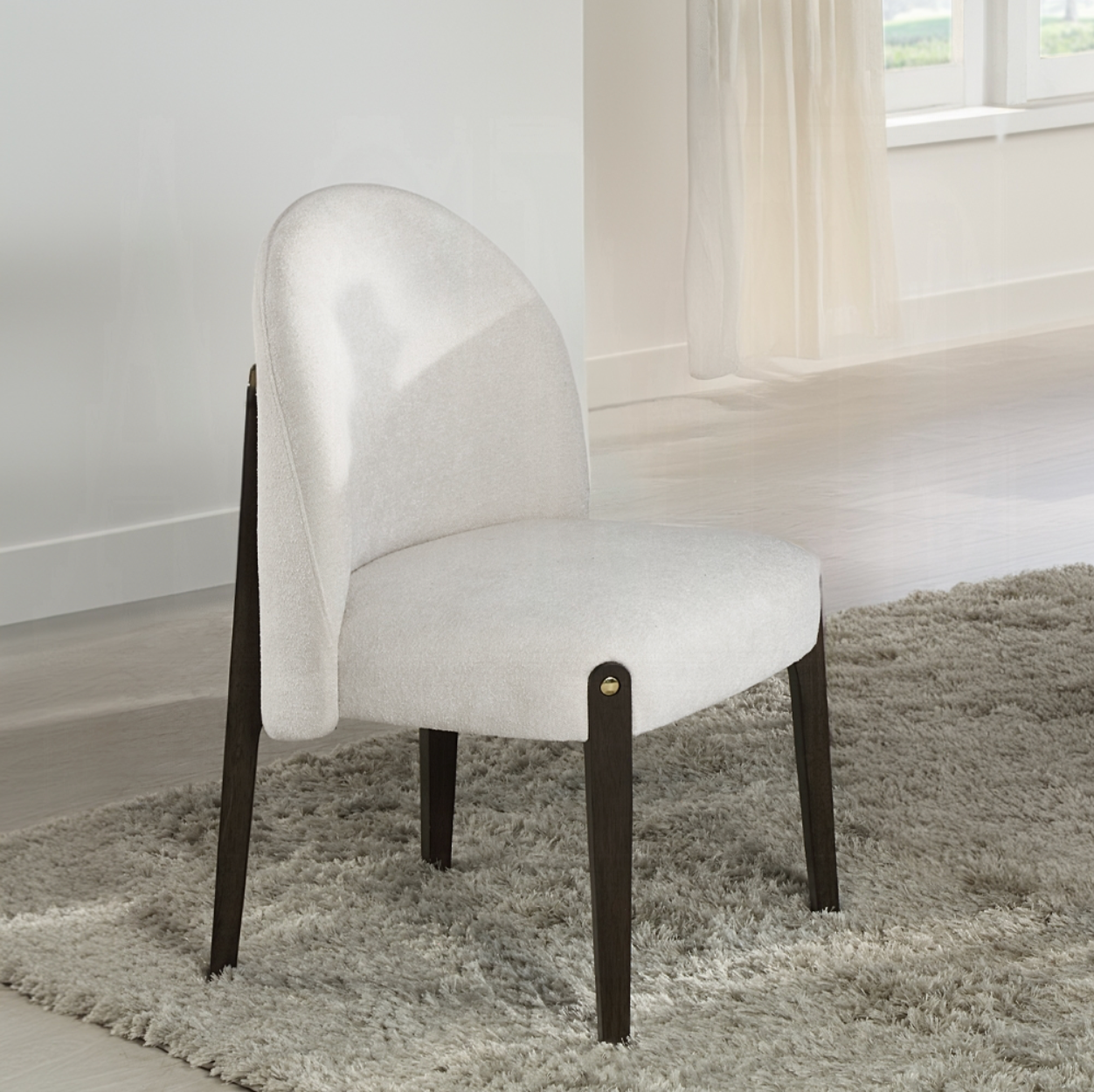 A white chair is sitting on a rug in a room
