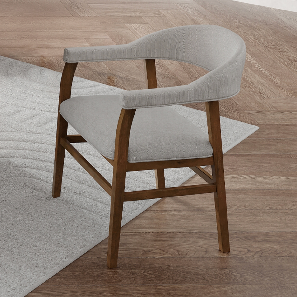 A chair is sitting on a rug on a wooden floor.