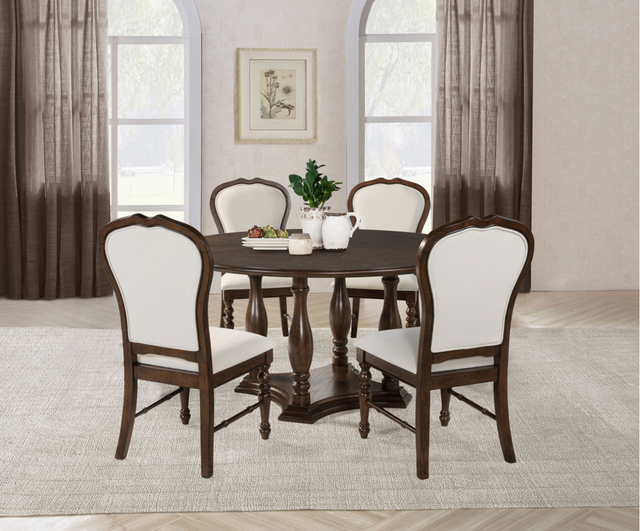 A dining room with a table and four chairs