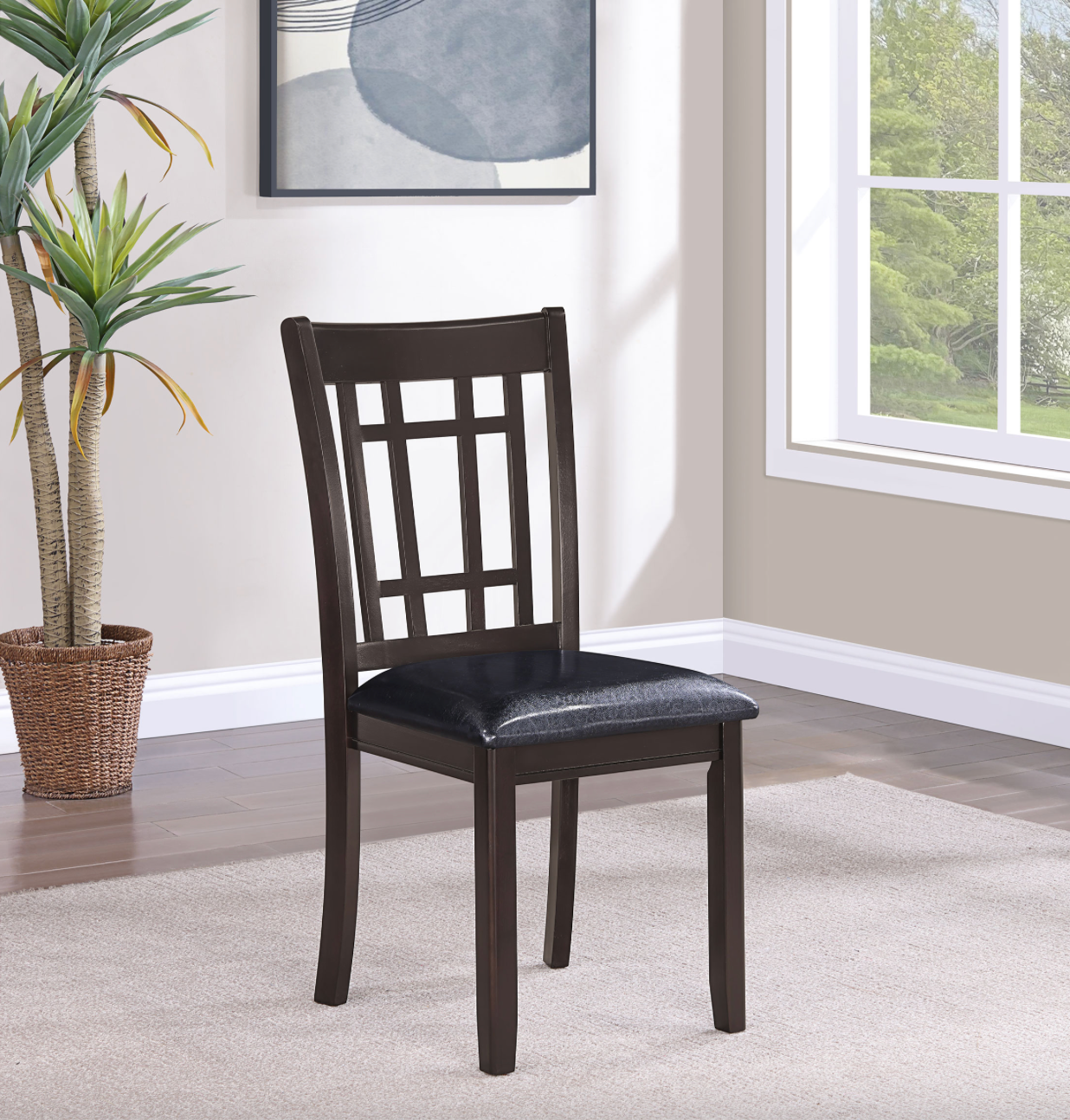 A chair in a living room next to a plant and a window