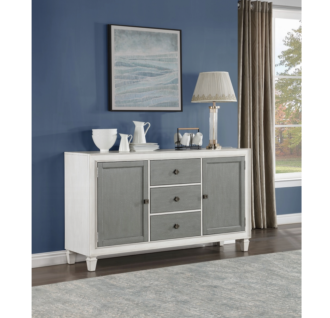 A white and gray dresser is in a living room with blue walls.