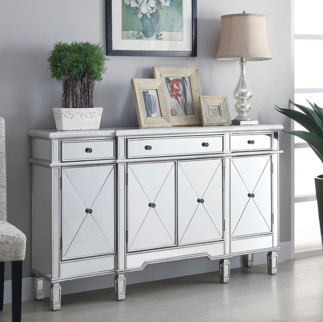 A white dresser with mirrored doors and drawers in a living room