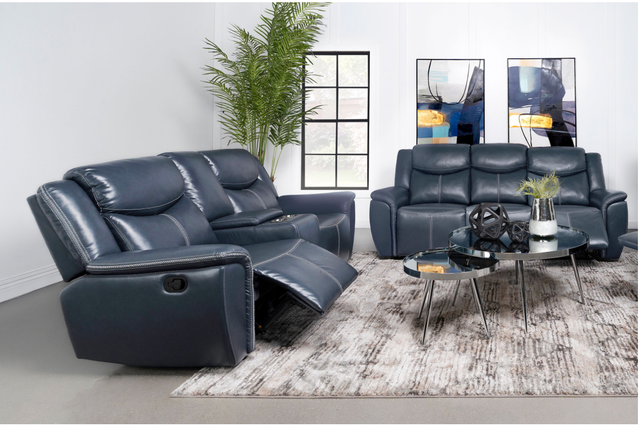 A living room with a blue leather recliner couch and a coffee table.
