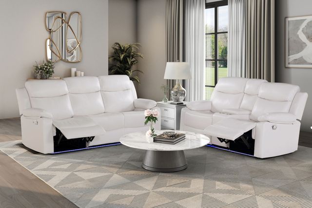 A living room with a white couch and a white coffee table