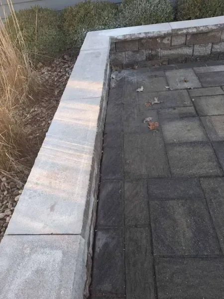 Stone patio with a raised concrete border.