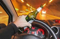 Man driving with the bottle in hand