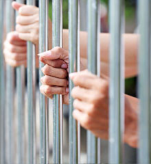 Hands behind the bars