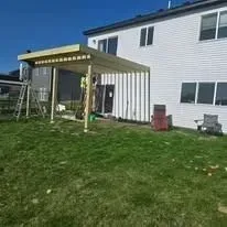 A house with a covered patio in front of it.