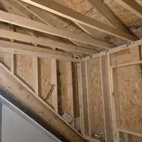 The inside of a house under construction with wooden beams.