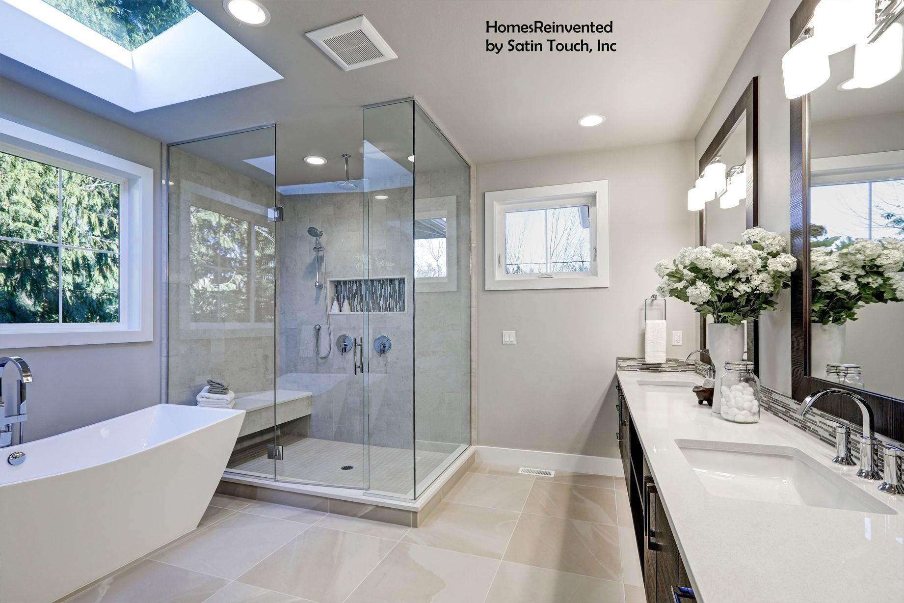 Modern bathroom with a glass shower, soaking tub, and double vanity.