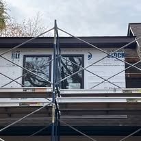 A house is being built with scaffolding around it.