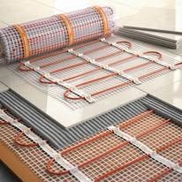 A roll of underfloor heating is sitting on top of a tiled floor.