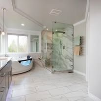 A bathroom with a tub and a walk in shower.