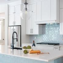 There is a bottle of wine on the counter in the kitchen.