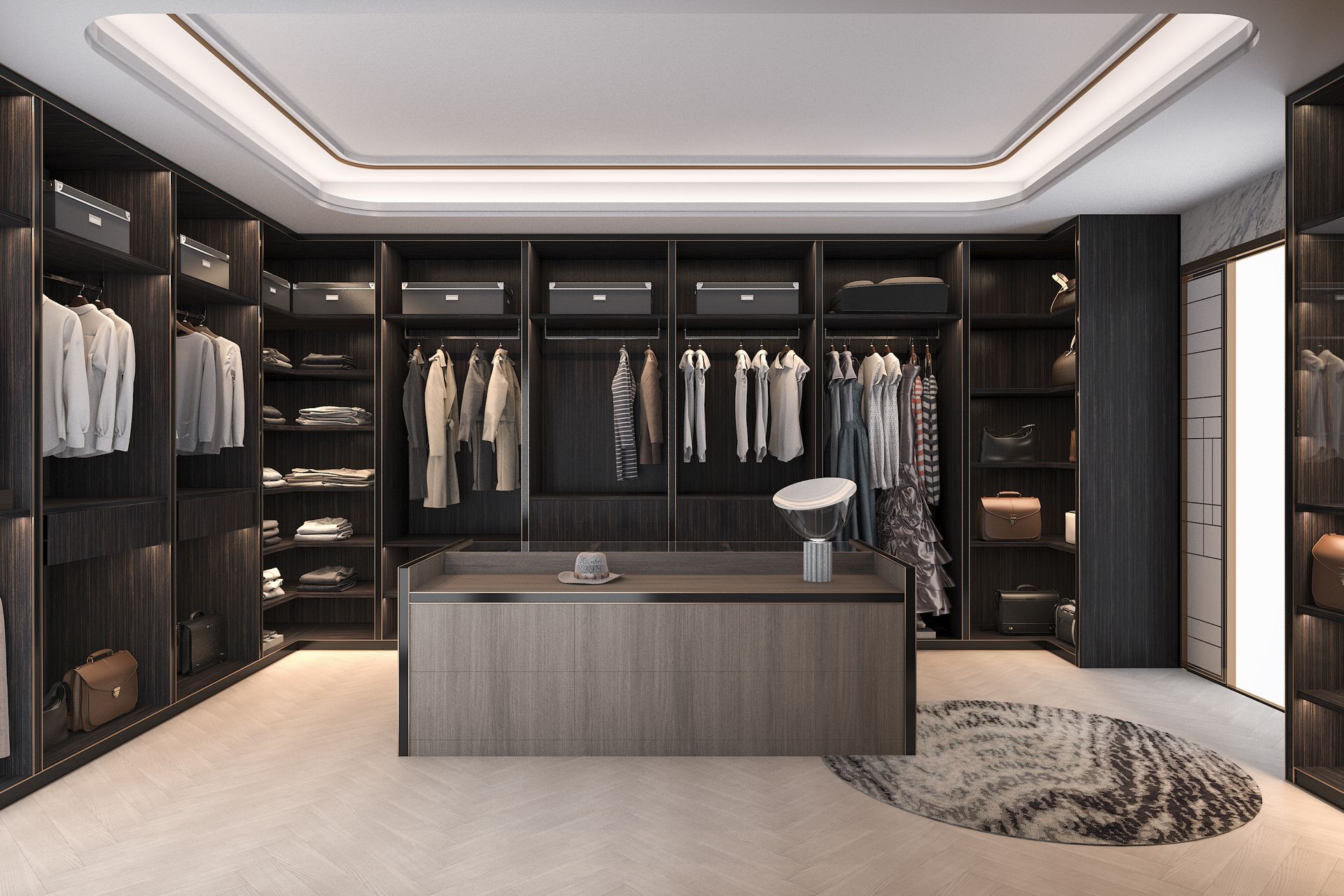Walk-in closet with dark wood shelving, clothing racks, and an island. Beige carpet and patterned rug.