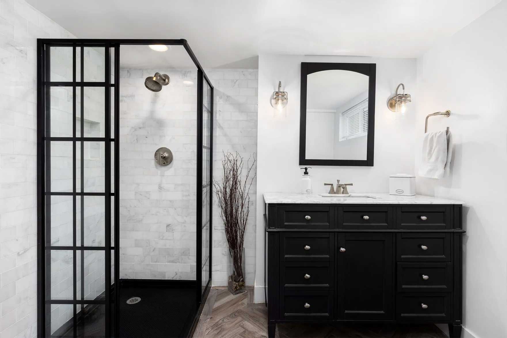 Black and white modern bathroom with shower and vanity.