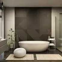 Modern bathroom with a white oval bathtub, decorative wall, and a round ottoman on a wooden mat.