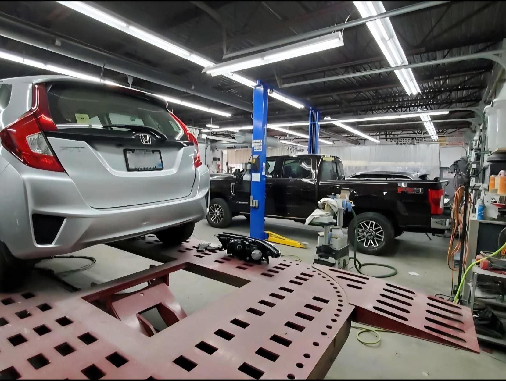 A car is sitting on a lift in a garage.