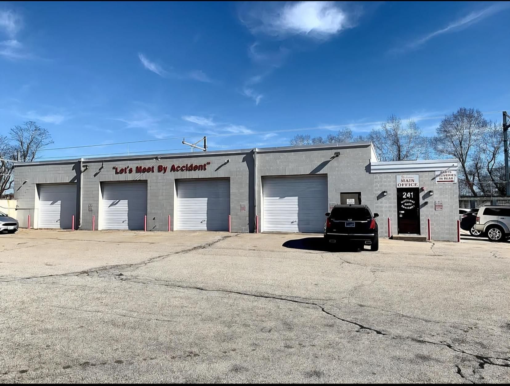 A car is parked in front of a building that says let 's move by accidents