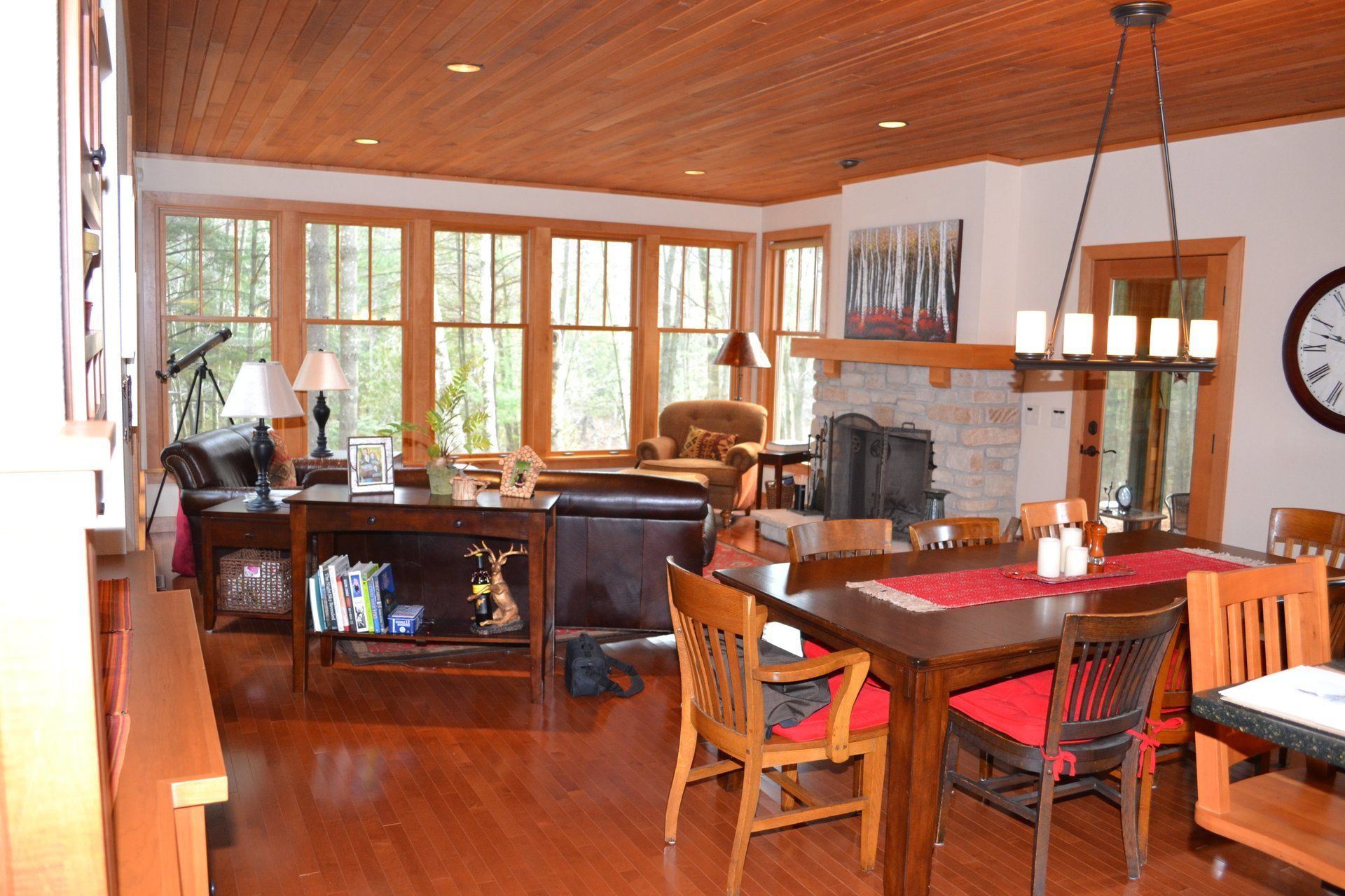 A living room with a table and chairs and a fireplace