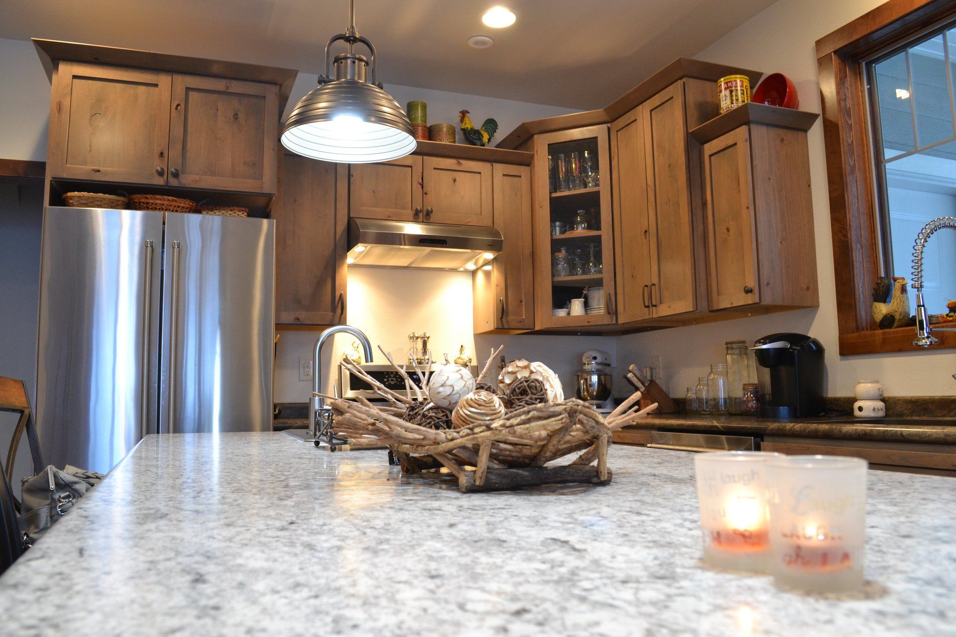 A kitchen with stainless steel appliances and wooden cabinets