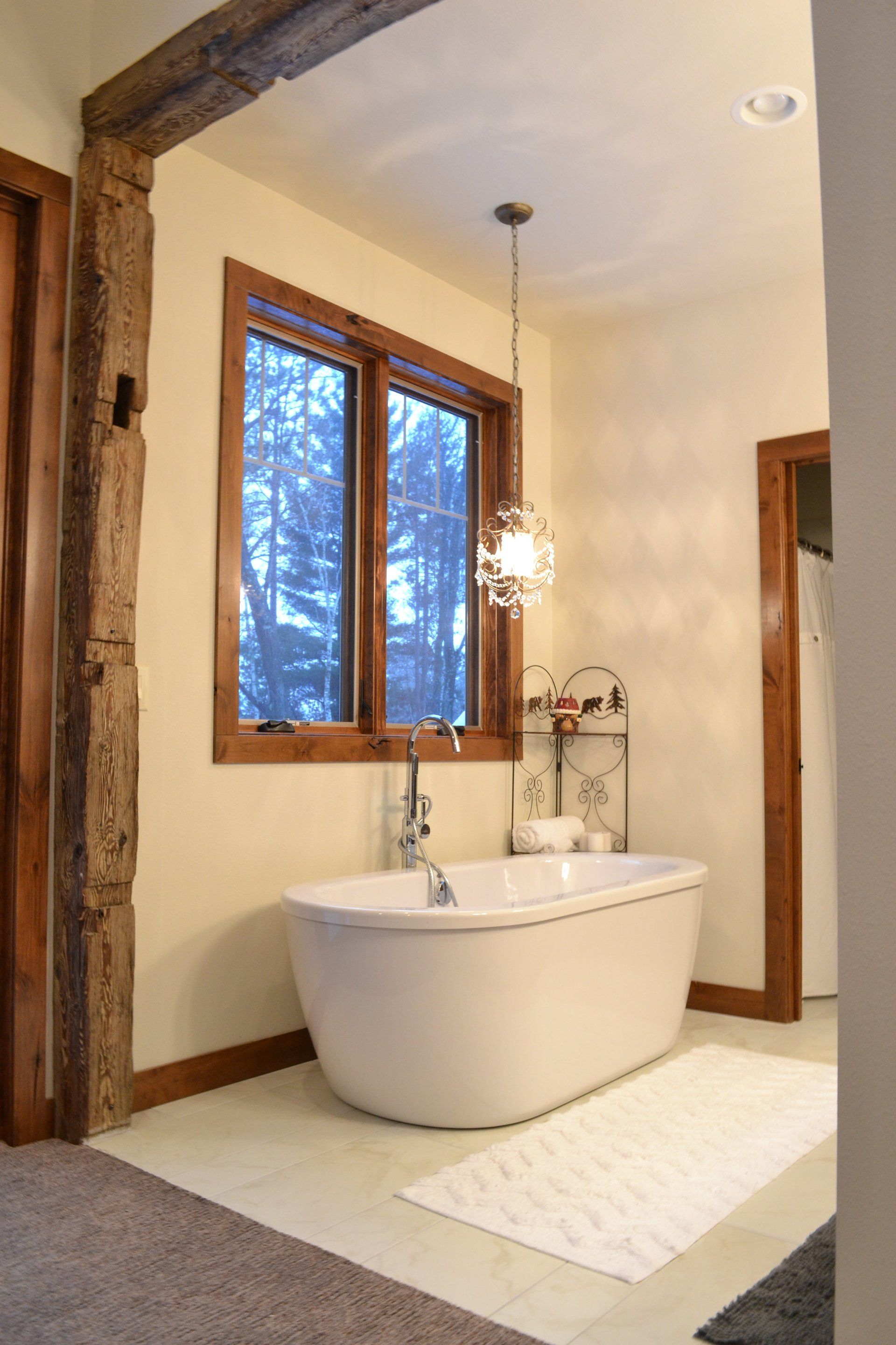 A bathroom with a tub and a window.