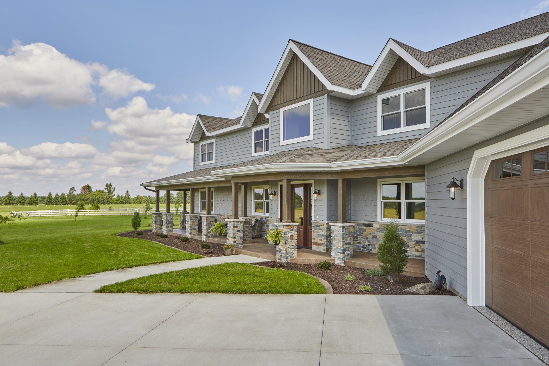 A large house with a large driveway and a garage.