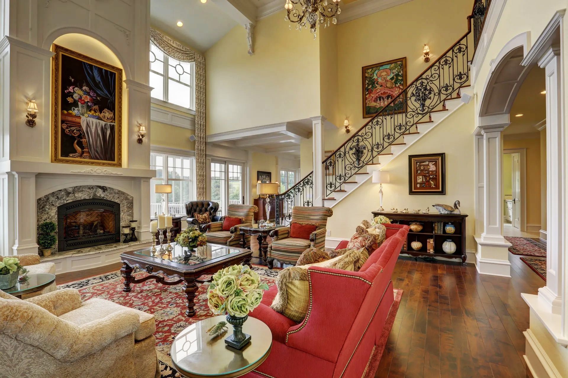 A living room with a red couch and stairs