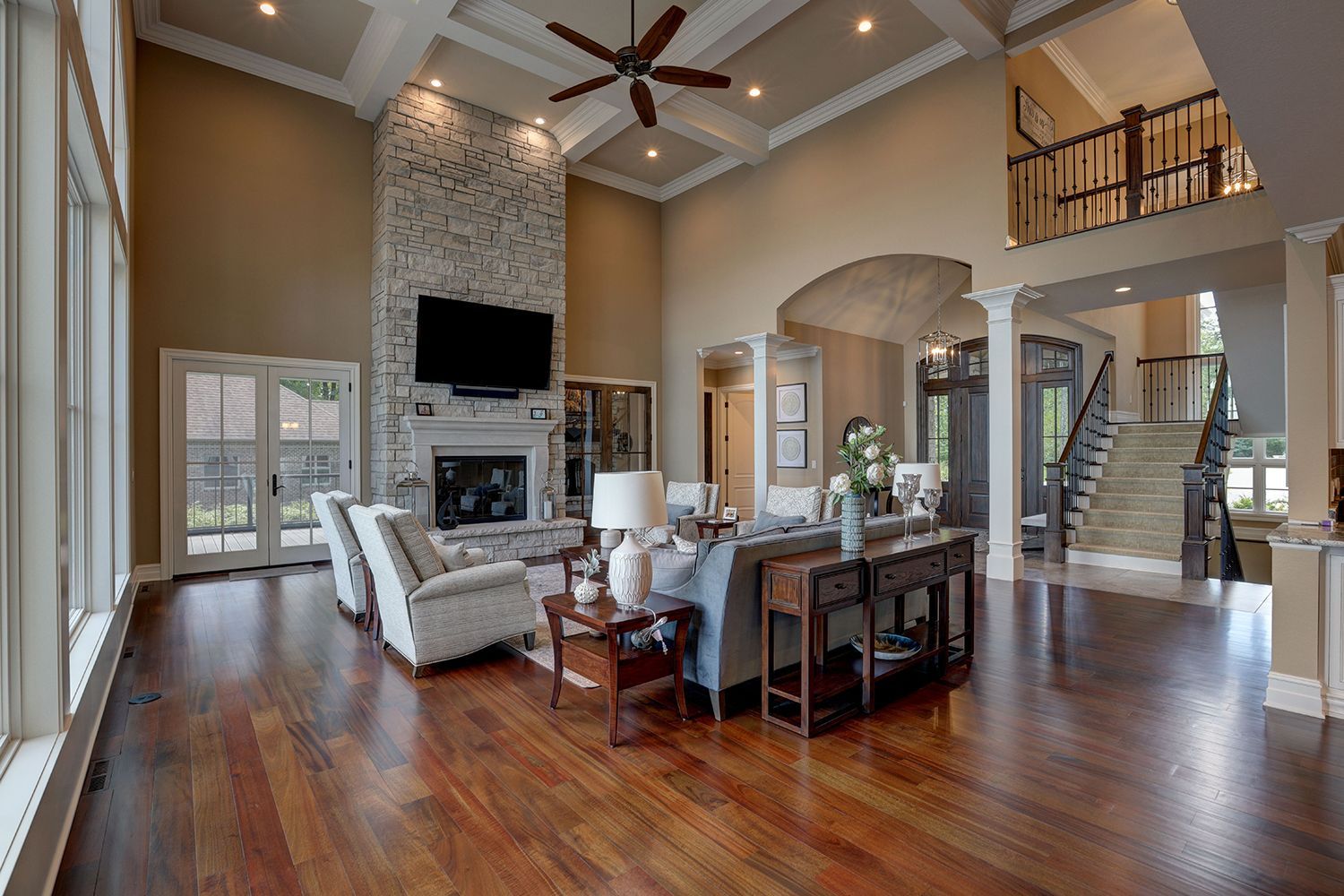 A living room in a house with hardwood floors and a fireplace.