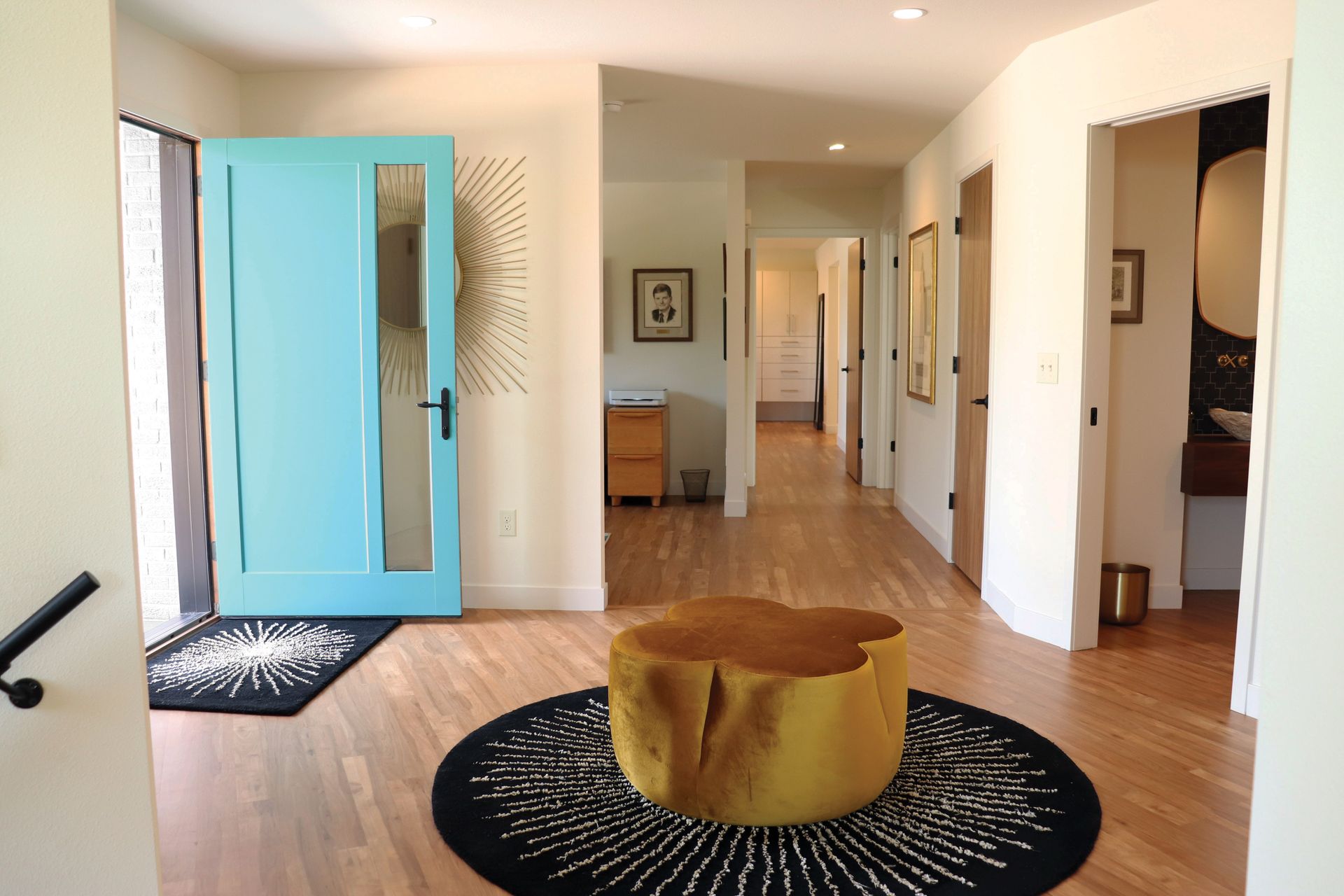 A living room with a blue door and a yellow table