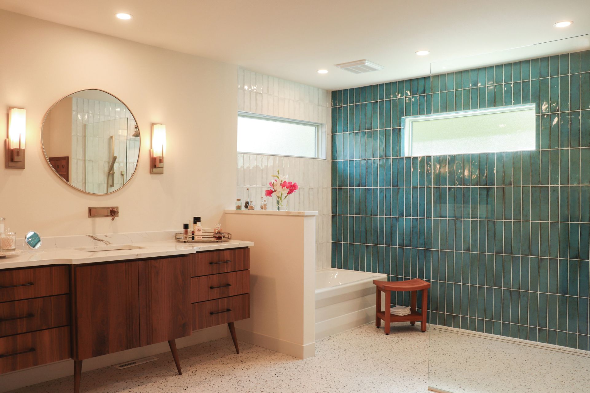 A bathroom with two sinks , a shower and a mirror.