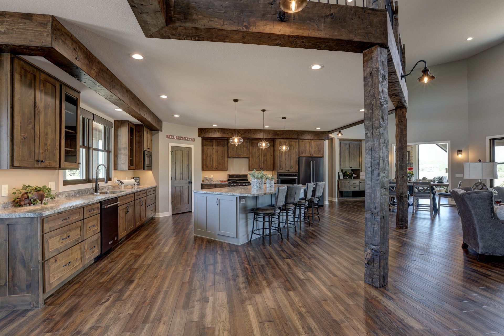 A kitchen with wooden cabinets and hardwood floors in a large house.