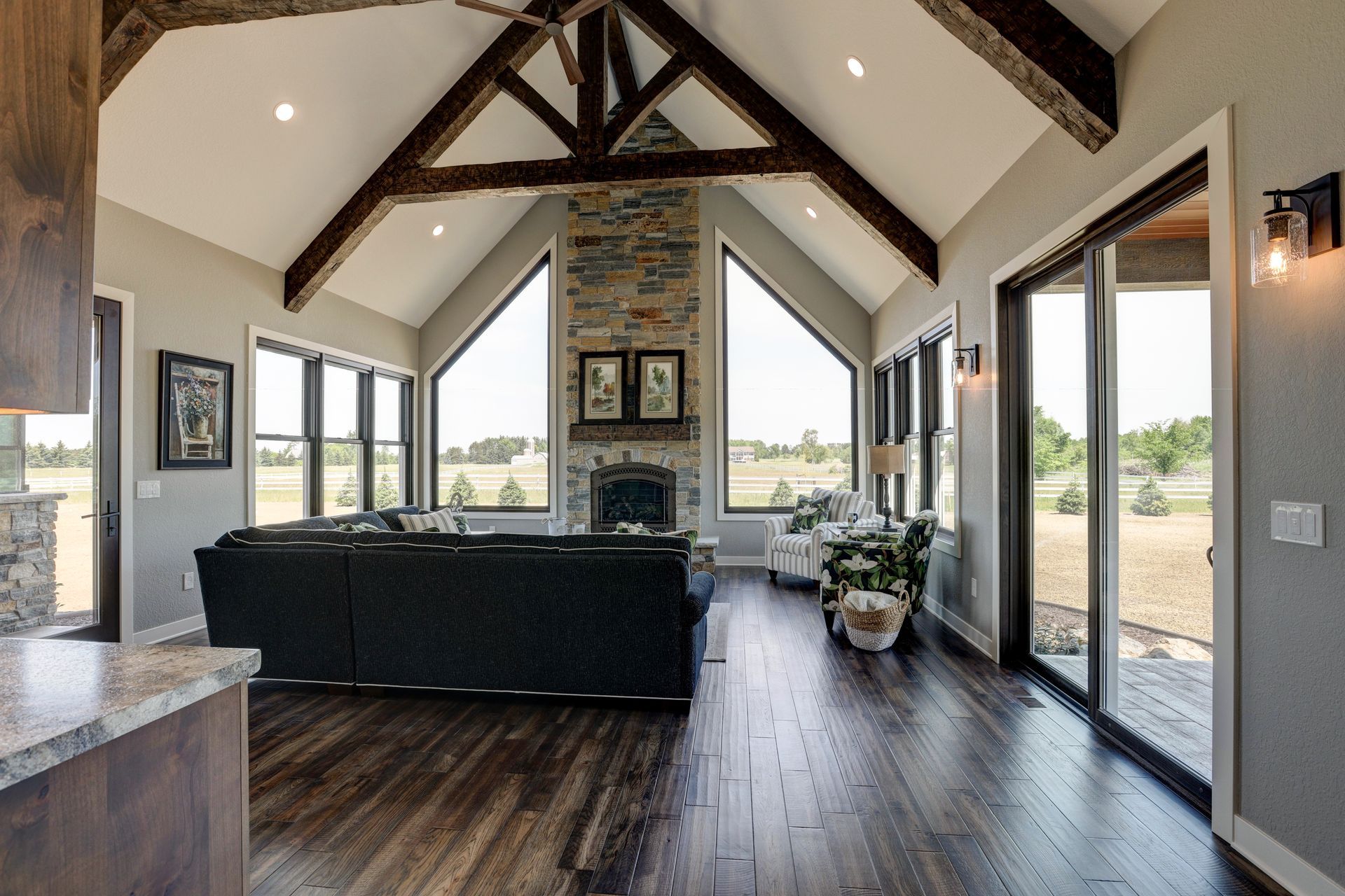 A living room with a fireplace and lots of windows