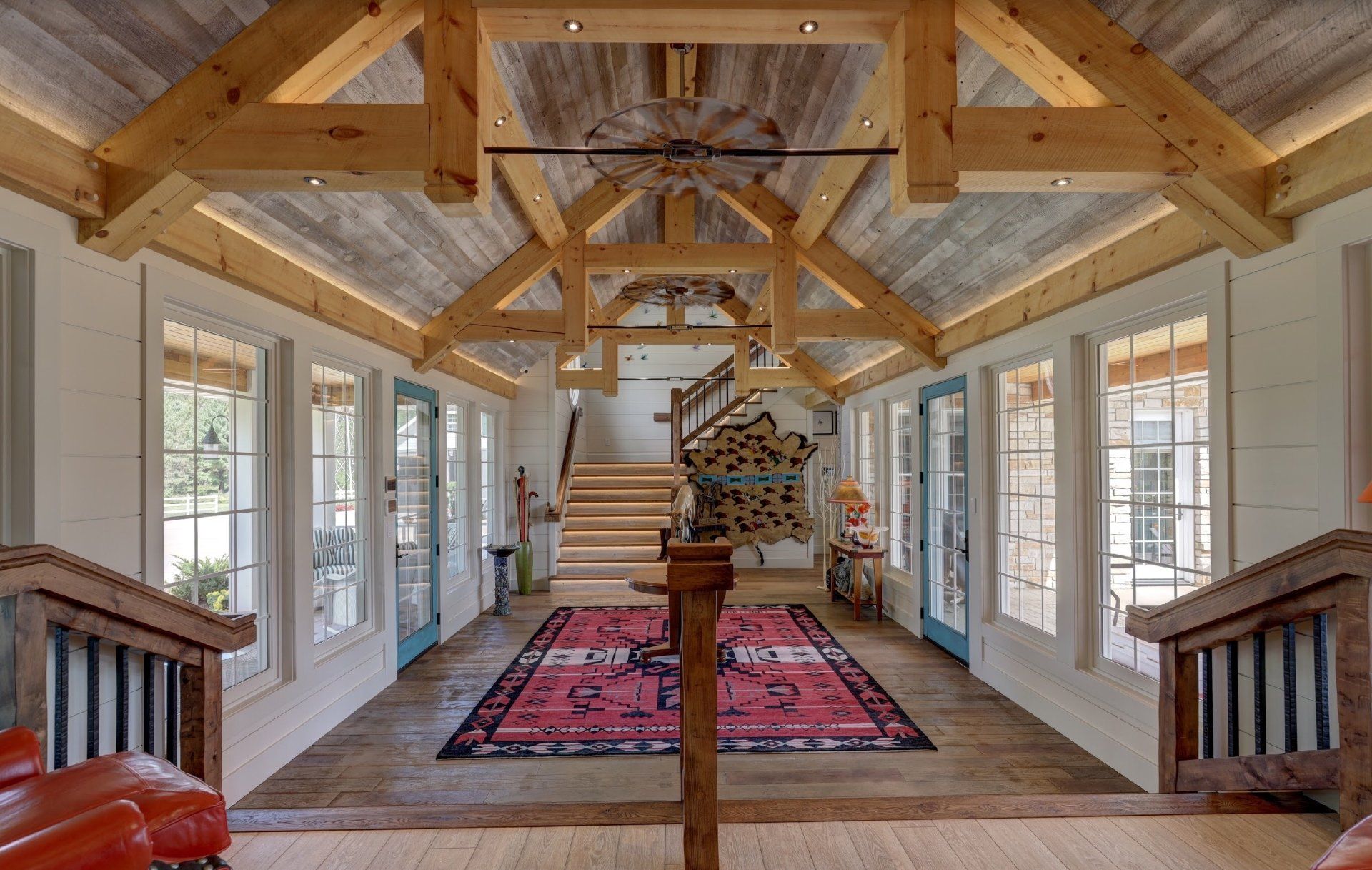 A large room with a wooden ceiling and stairs