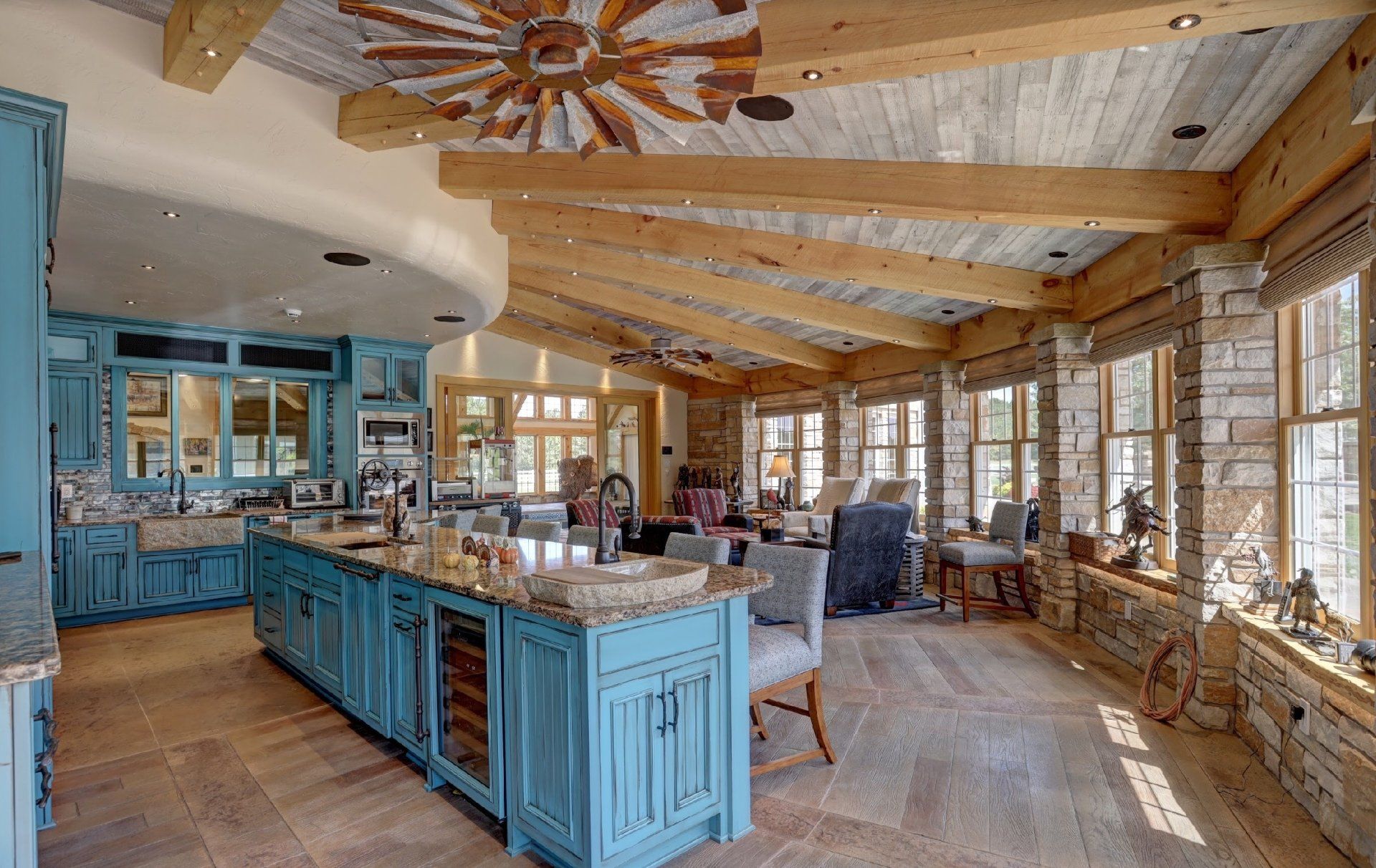 A large kitchen with blue cabinets and a wooden ceiling.