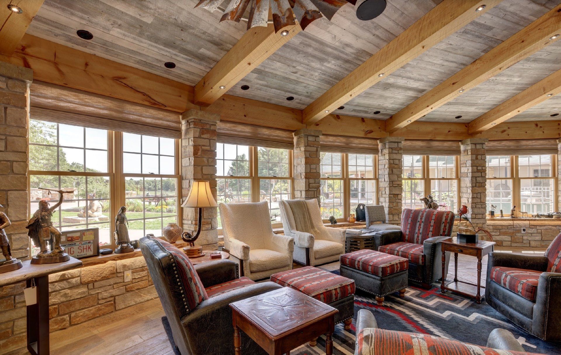A living room with a lot of furniture and a ceiling fan