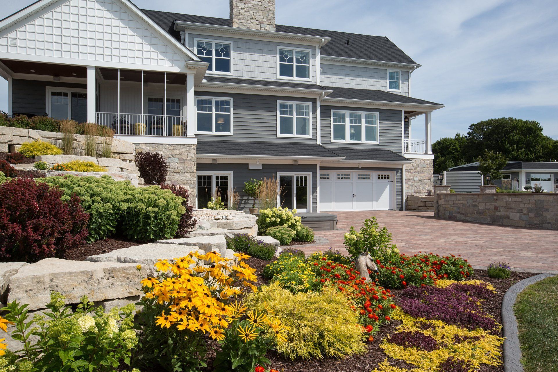A large house with a lot of flowers in front of it