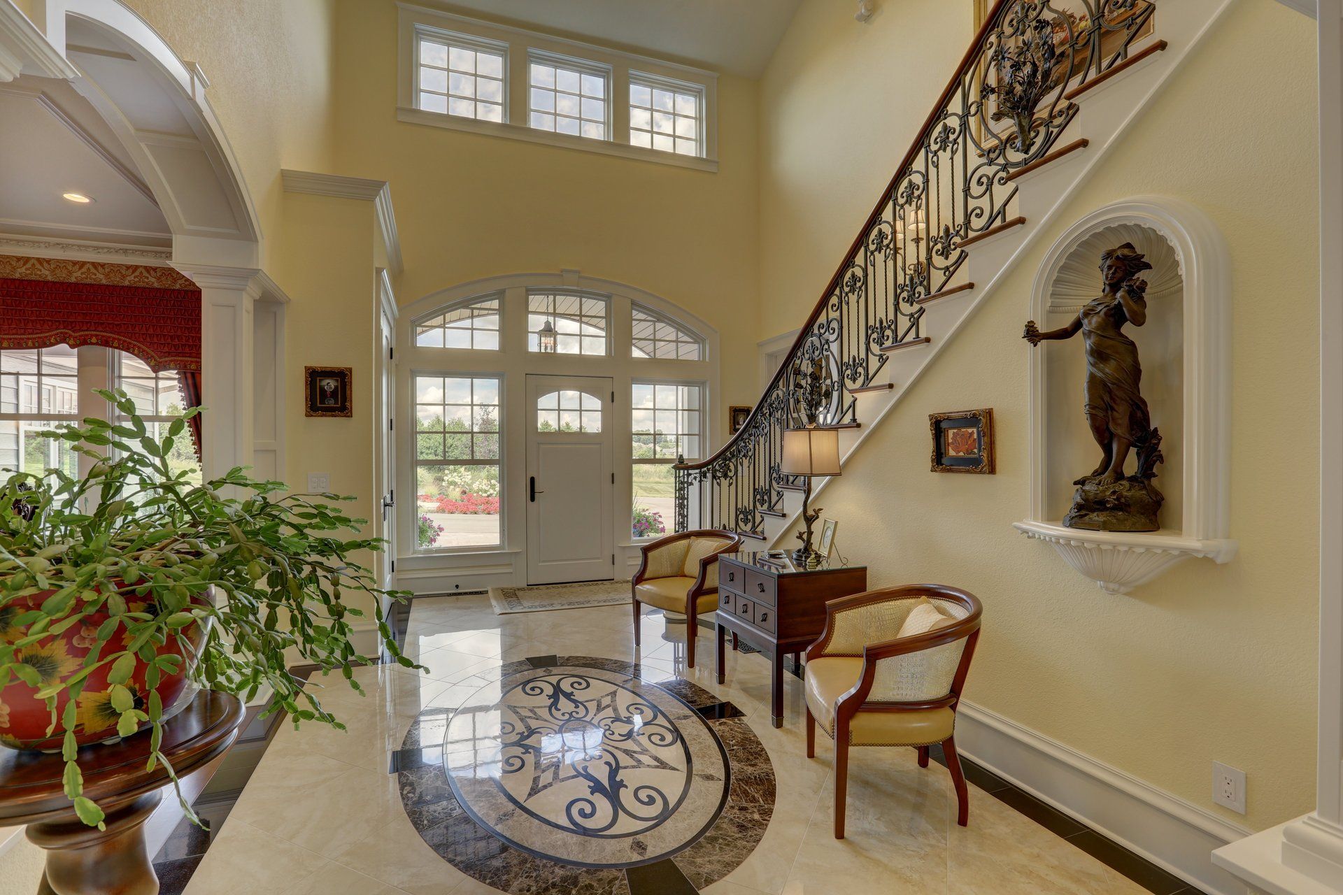 A hallway with a staircase and a statue on the wall
