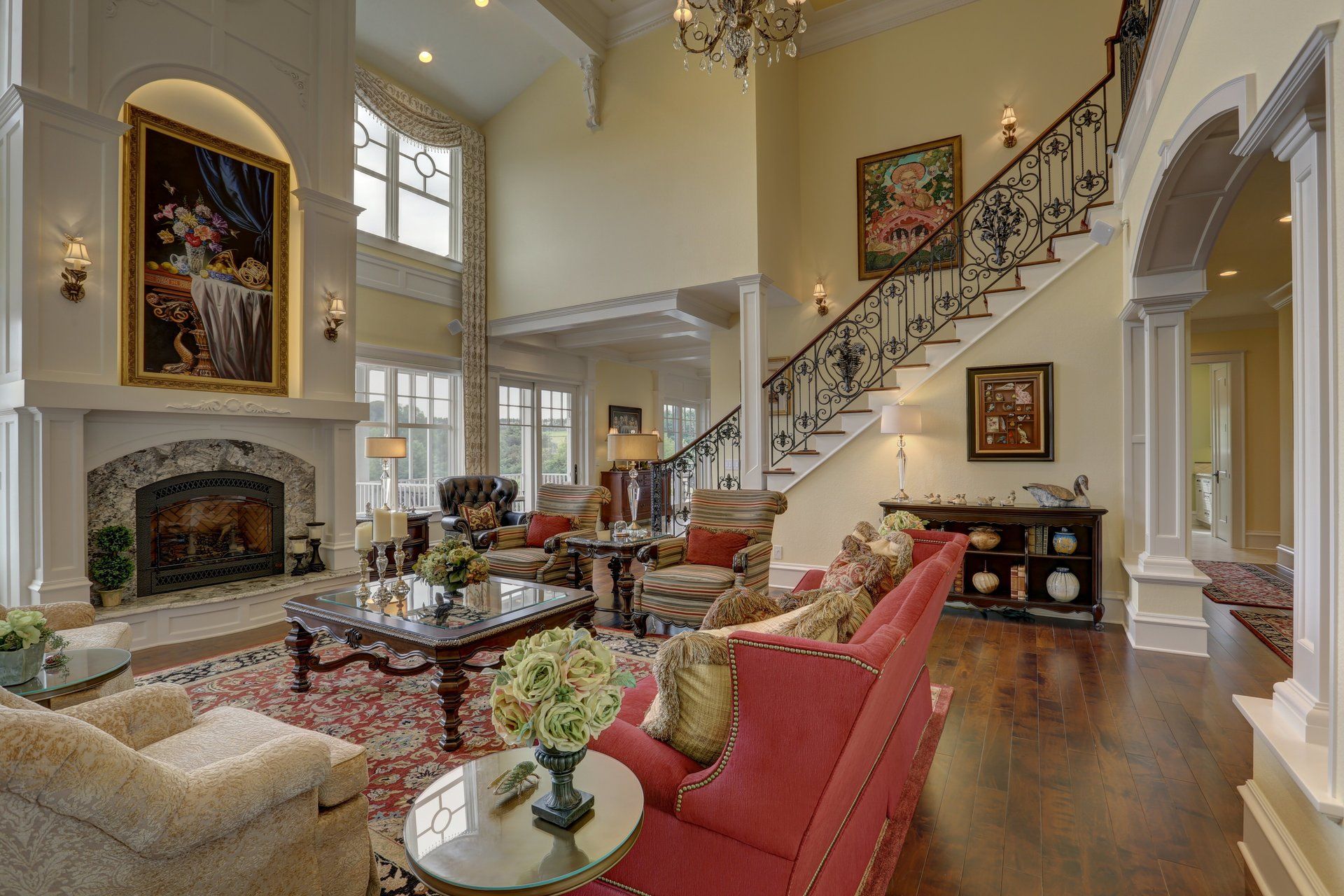 A living room with a red couch and stairs