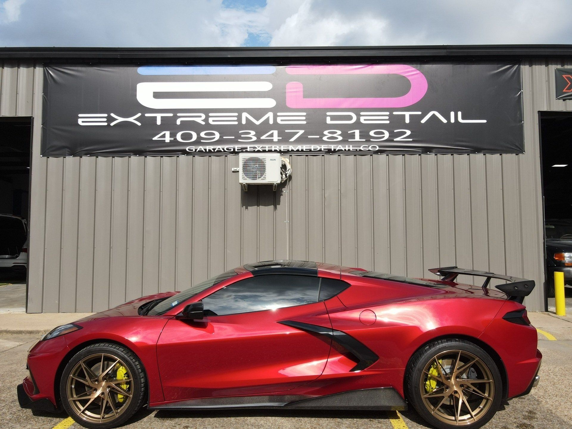 A red sports car is parked in front of a building.